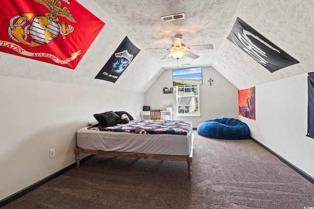 bedroom featuring vaulted ceiling, a textured ceiling, ceiling fan, and carpet floors