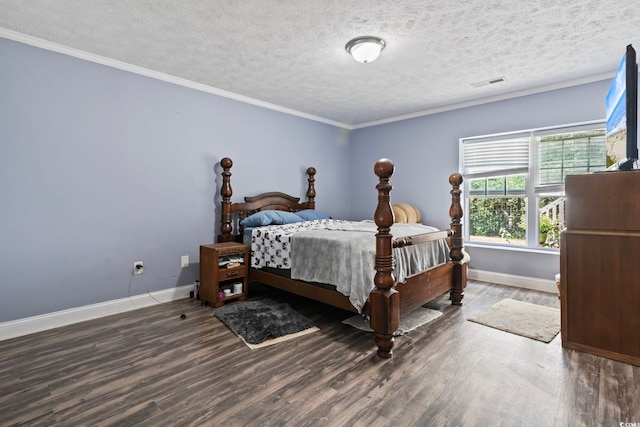 bedroom with dark hardwood / wood-style floors and a textured ceiling