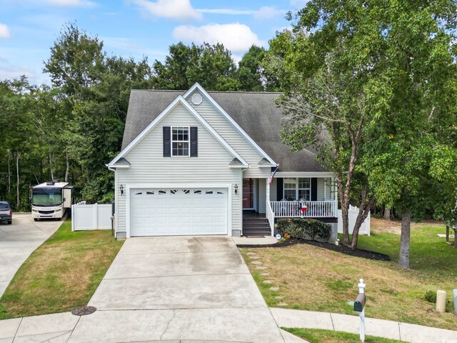 view of front of property with a garage, a porch, and a front lawn