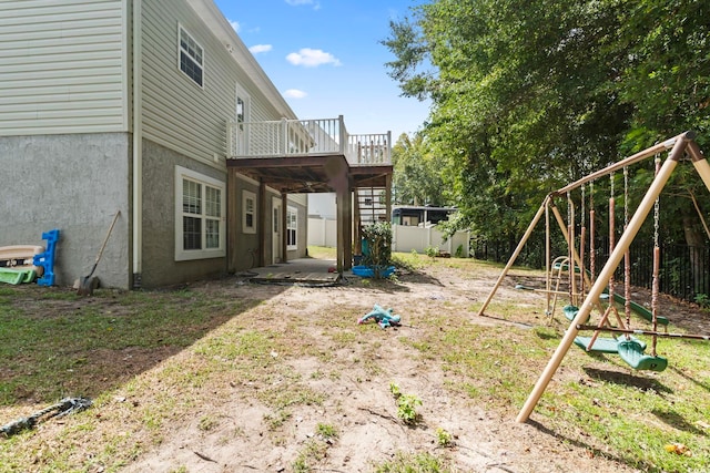 view of yard featuring a playground and a deck