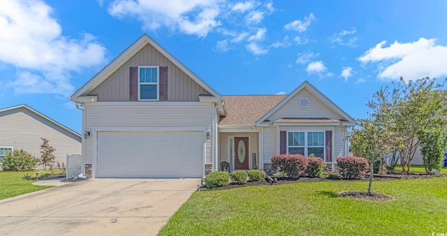 view of front of house with a front yard and a garage