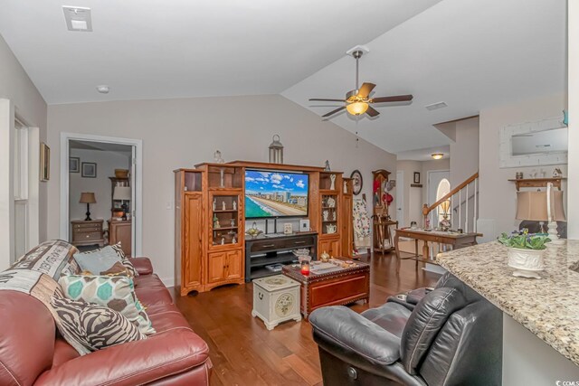 living room featuring vaulted ceiling, dark hardwood / wood-style flooring, and ceiling fan