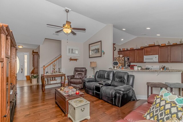 living room featuring lofted ceiling, ceiling fan, and light wood-type flooring