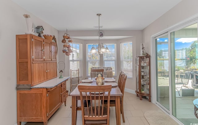 dining area featuring an inviting chandelier and light tile patterned floors