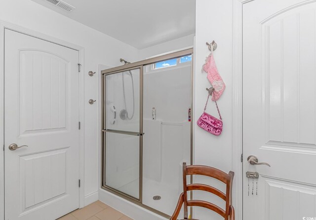 bathroom featuring tile patterned floors and a shower with door