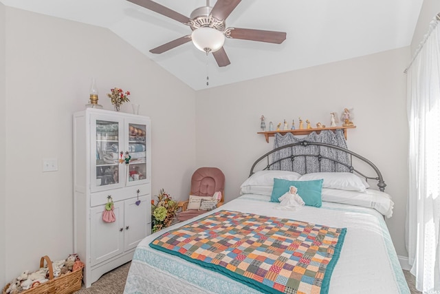 carpeted bedroom featuring lofted ceiling and ceiling fan