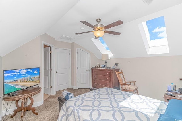 carpeted bedroom with ceiling fan and lofted ceiling with skylight