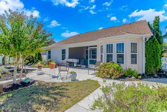 rear view of property with a patio and an outdoor hangout area