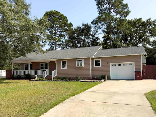 single story home with a porch, a garage, and a front yard