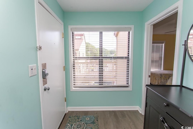 hallway with hardwood / wood-style flooring