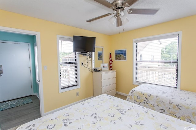 bedroom featuring ceiling fan and dark hardwood / wood-style floors