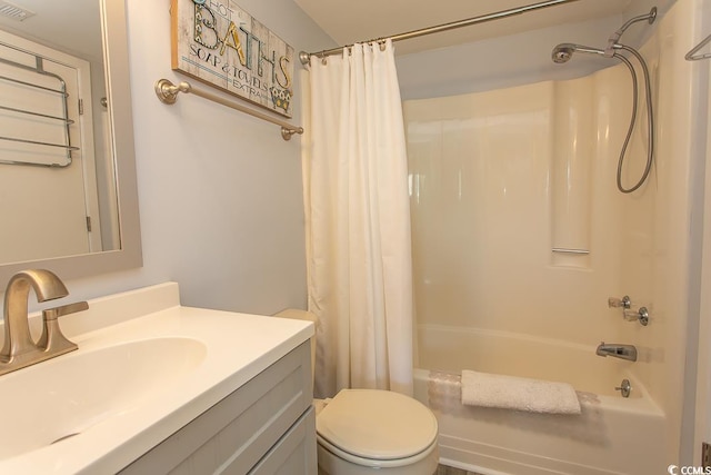 full bathroom featuring vanity, shower / bath combo with shower curtain, and toilet