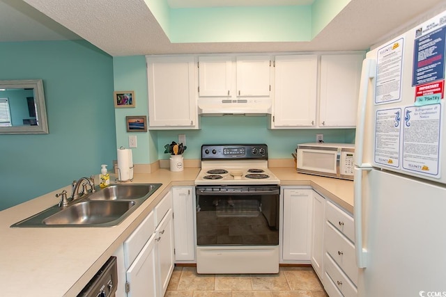 kitchen featuring sink, white appliances, and white cabinetry