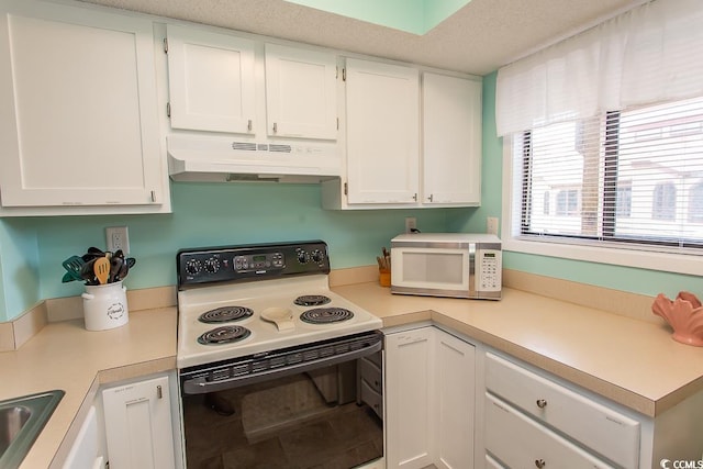 kitchen featuring white cabinets, a textured ceiling, and white appliances