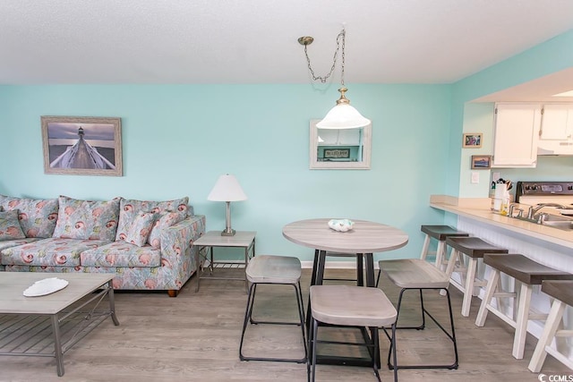 dining area featuring light wood-type flooring