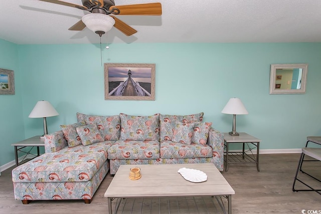 living room featuring ceiling fan and hardwood / wood-style floors