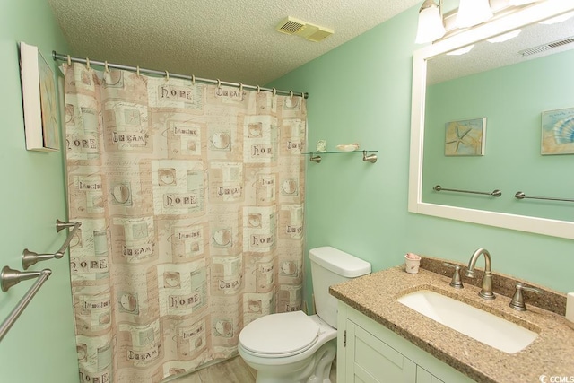 bathroom featuring vanity, toilet, a textured ceiling, and a shower with shower curtain