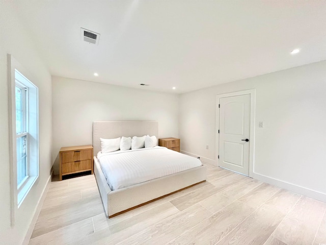 bedroom featuring light wood-type flooring and multiple windows