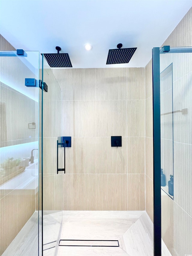 bathroom with a shower with door