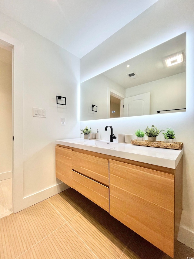 bathroom with tile patterned flooring and vanity