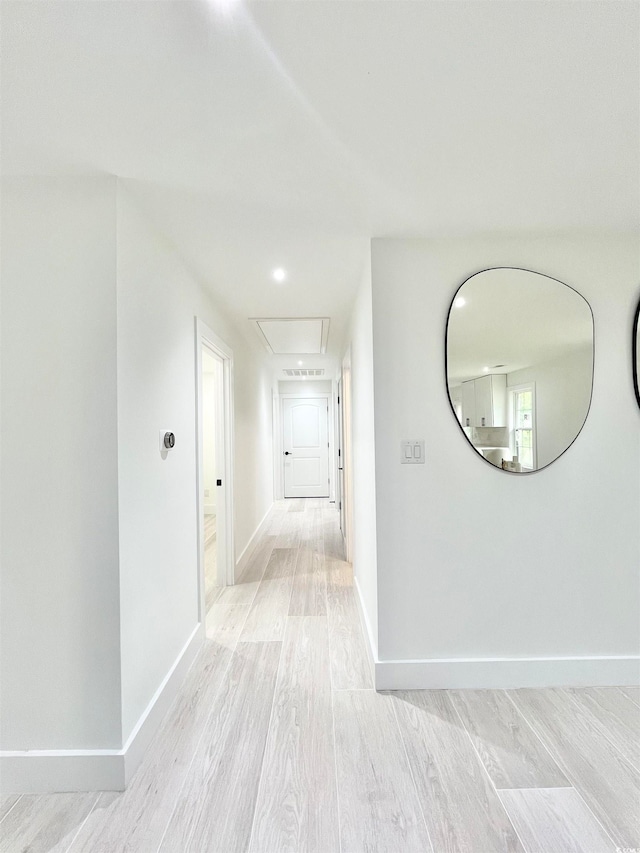 corridor with light wood-type flooring