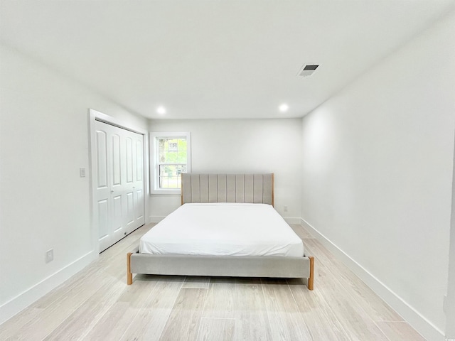 bedroom with a closet and light hardwood / wood-style floors