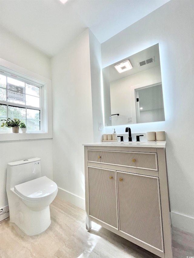 bathroom featuring vanity and toilet