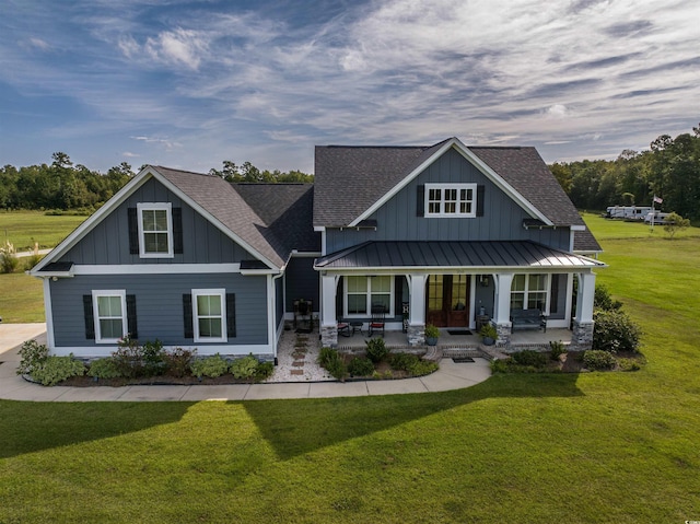 craftsman house featuring a porch and a front yard