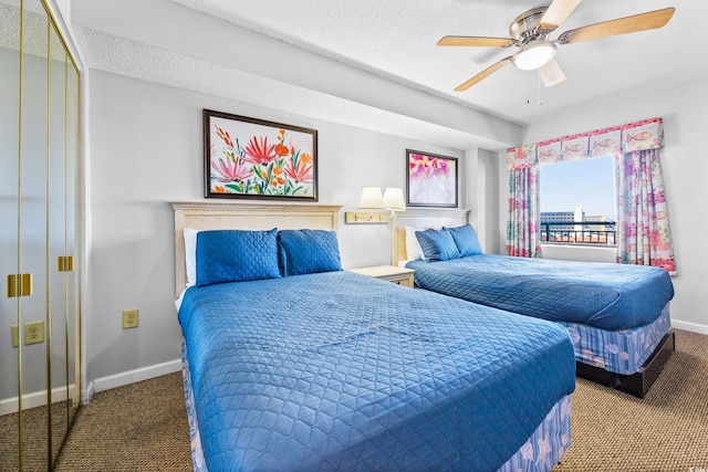 carpeted bedroom featuring a textured ceiling, ceiling fan, and a closet