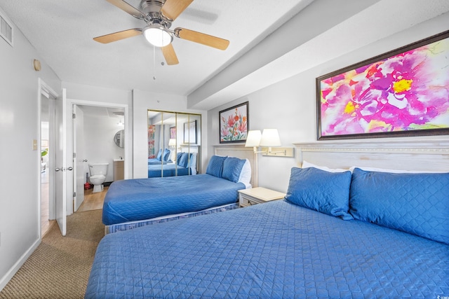 carpeted bedroom featuring multiple windows, ceiling fan, and a closet