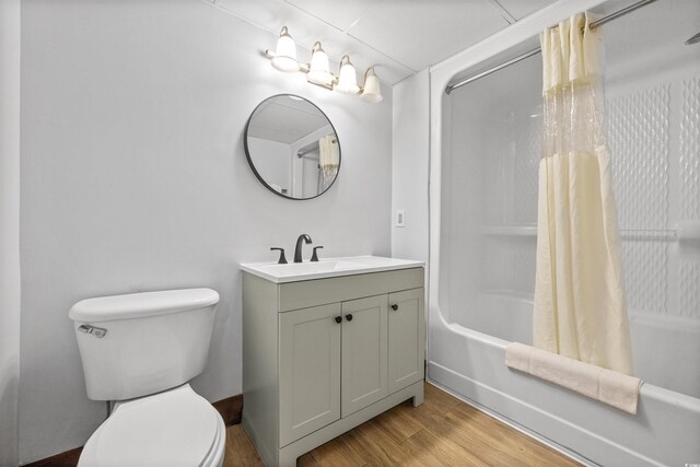 full bathroom with vanity, toilet, shower / tub combo with curtain, and hardwood / wood-style floors