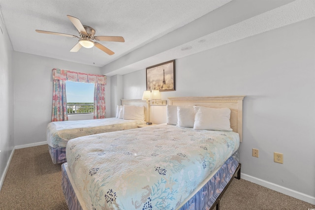 bedroom featuring a textured ceiling, ceiling fan, and carpet