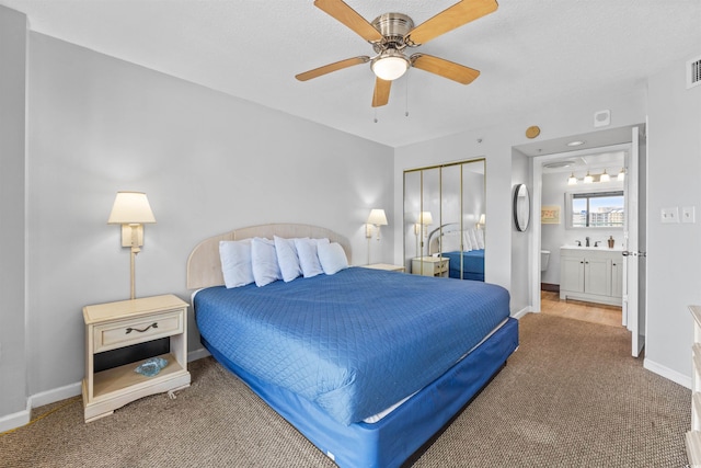 bedroom featuring carpet flooring, connected bathroom, ceiling fan, and a closet