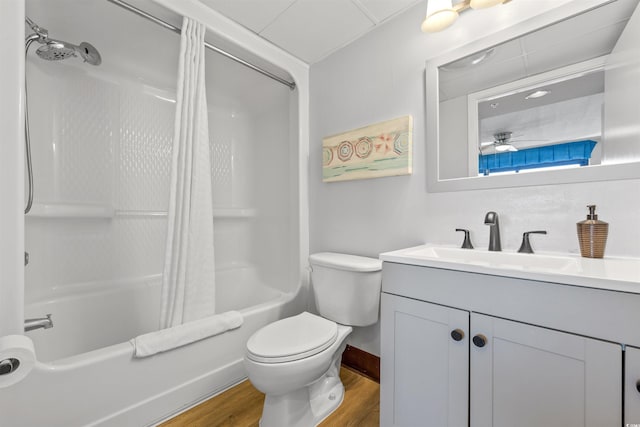 full bathroom with toilet, vanity, shower / bathtub combination with curtain, ceiling fan, and hardwood / wood-style flooring