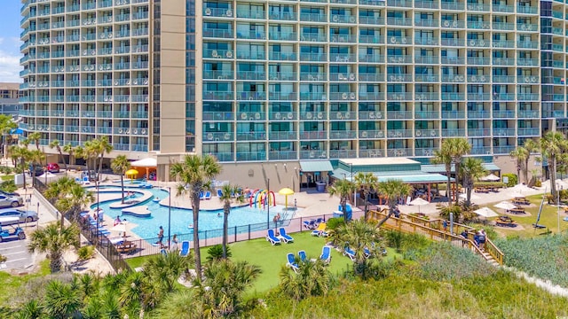 view of building exterior featuring a community pool