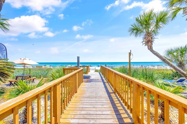 view of property's community with a water view and a view of the beach