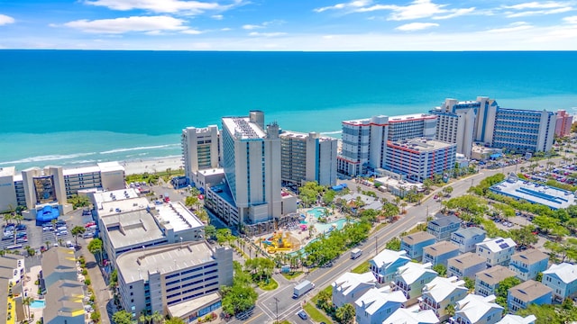 bird's eye view with a water view and a beach view