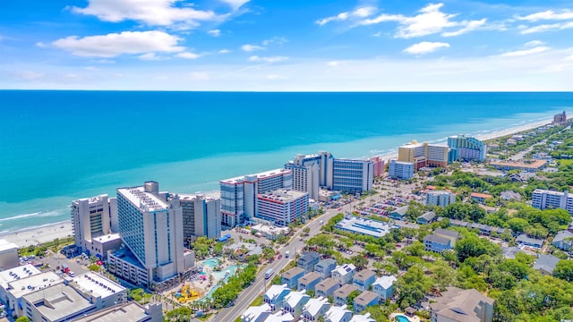 drone / aerial view with a beach view and a water view