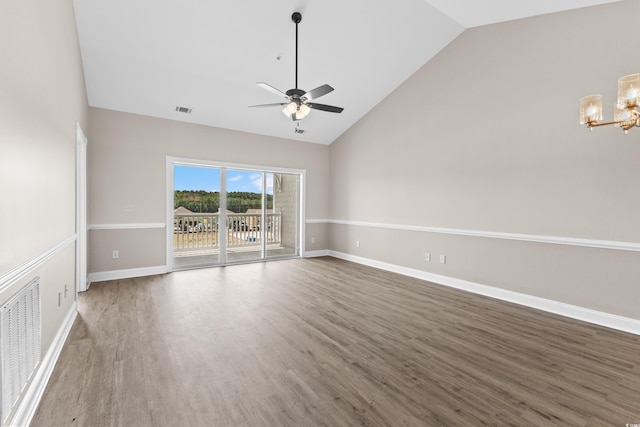 unfurnished living room featuring ceiling fan with notable chandelier, dark hardwood / wood-style floors, and high vaulted ceiling