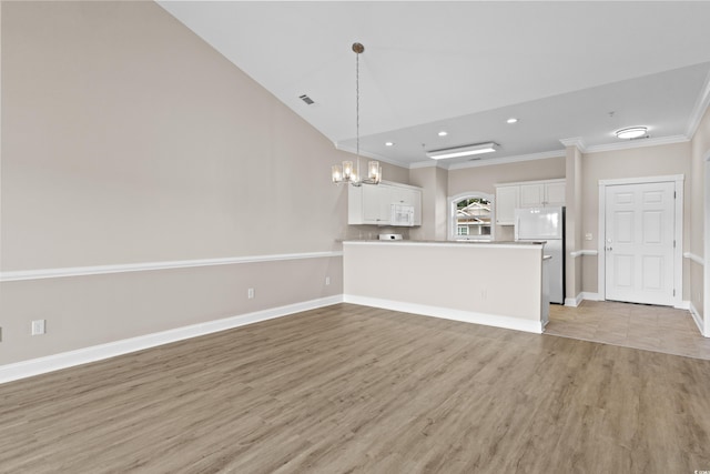 unfurnished living room with ornamental molding, light wood-type flooring, a chandelier, and lofted ceiling