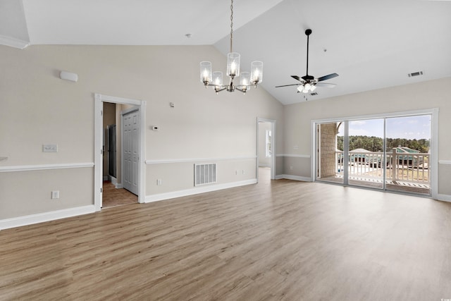 unfurnished room with ceiling fan with notable chandelier, light hardwood / wood-style flooring, and high vaulted ceiling