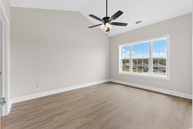 spare room with ceiling fan, light hardwood / wood-style floors, and vaulted ceiling