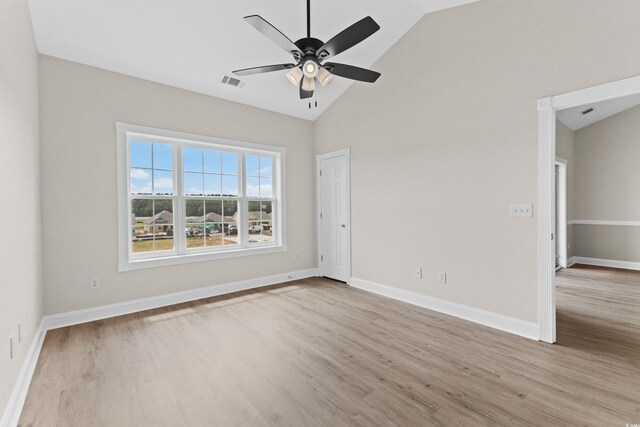 empty room with ceiling fan, light hardwood / wood-style floors, and high vaulted ceiling