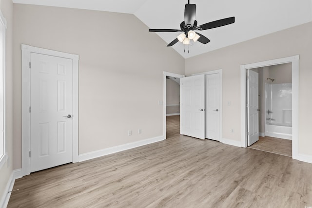 unfurnished bedroom with vaulted ceiling, ensuite bath, light hardwood / wood-style flooring, and ceiling fan