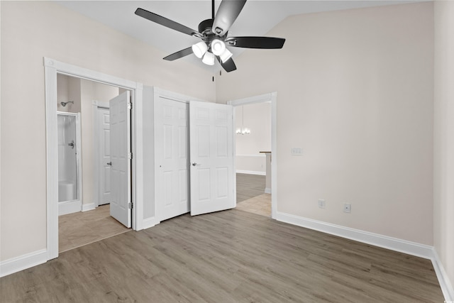 unfurnished bedroom featuring ceiling fan, light wood-type flooring, and lofted ceiling