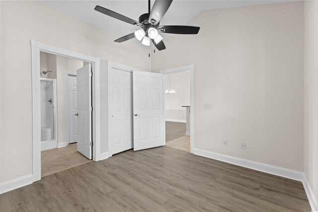 124 S Shore Blvd Unit 303, Longs, SC 29568 - unfurnished bedroom featuring vaulted ceiling, wood finished floors, a chandelier, connected bathroom, and a closet