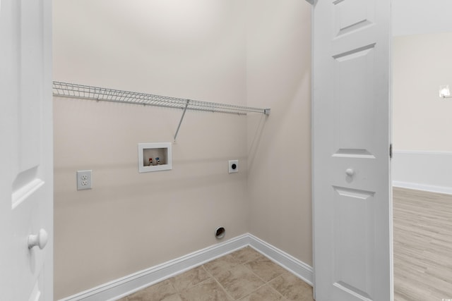 laundry room with hookup for a washing machine, light wood-type flooring, and electric dryer hookup