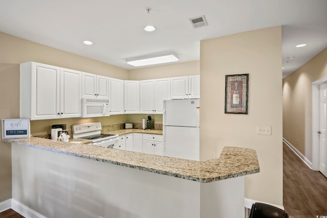 kitchen featuring white cabinets, white appliances, light stone countertops, and kitchen peninsula