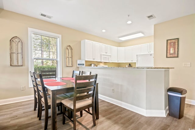 dining area with hardwood / wood-style flooring