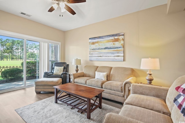 living room with ceiling fan and hardwood / wood-style floors